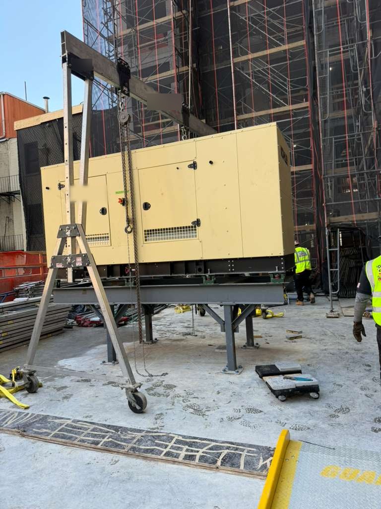 Portable gantry and chain hoist set up beside a standby generator in New York City