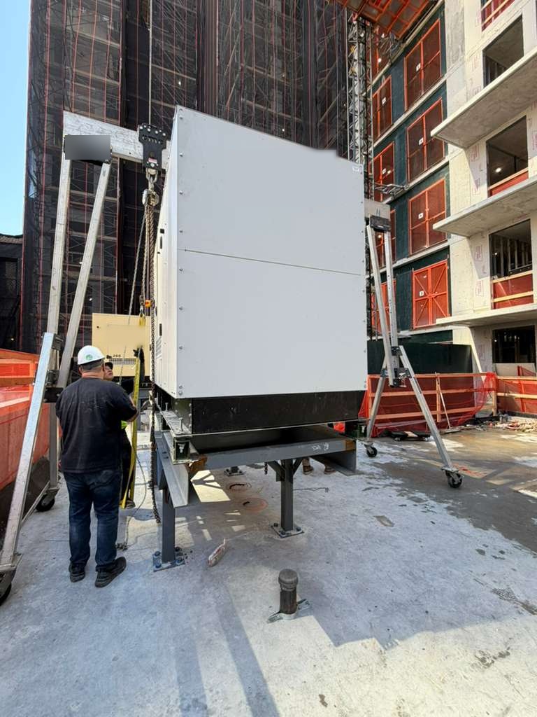 Standby generator lowered onto its steel frame by gantry at a NYC high-rise