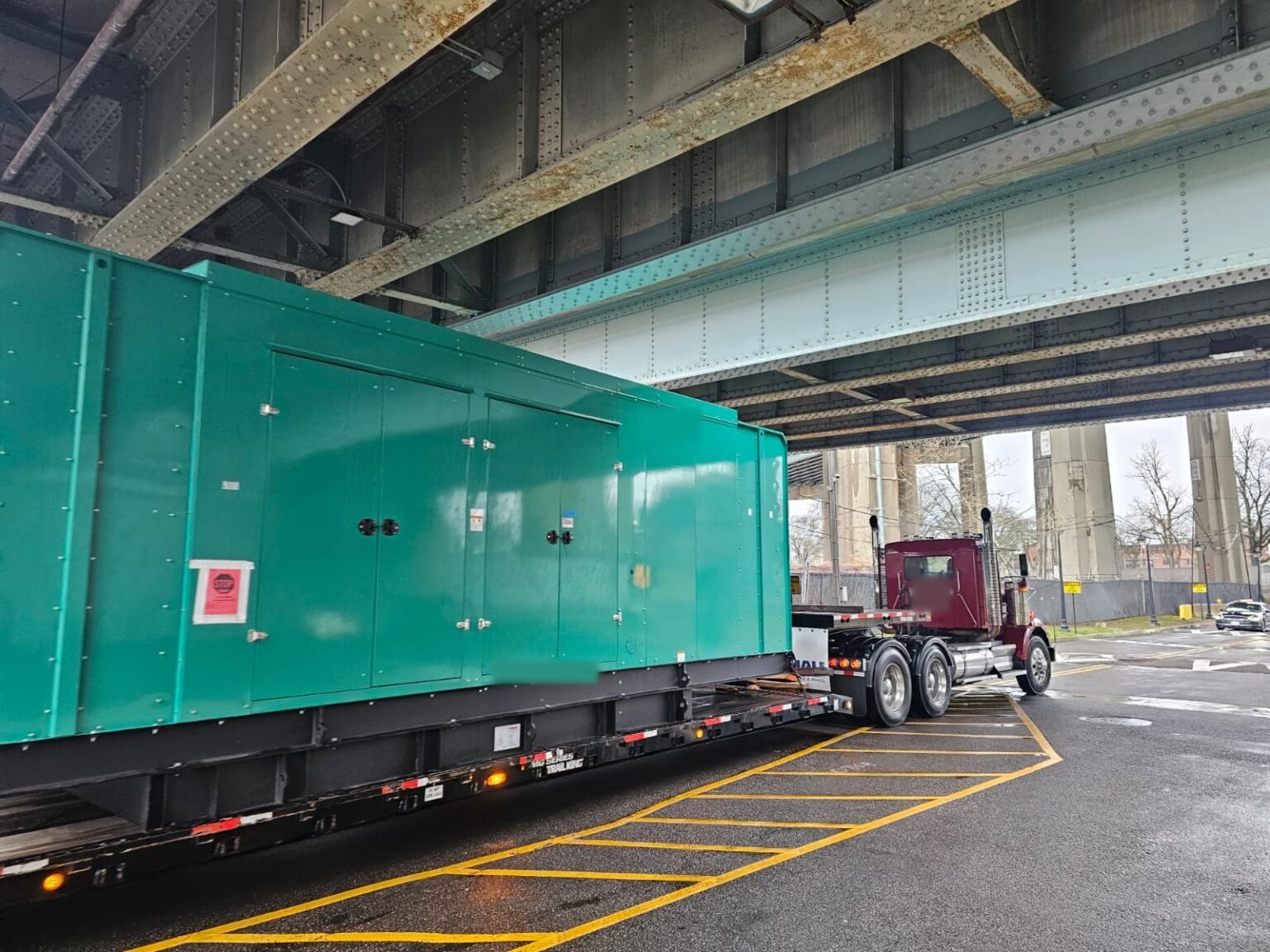 Standby generator on a lowboy trailer clearing a bridge in New York City