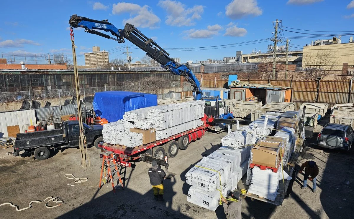 Crane and rigging scope managed across a live New York City construction site